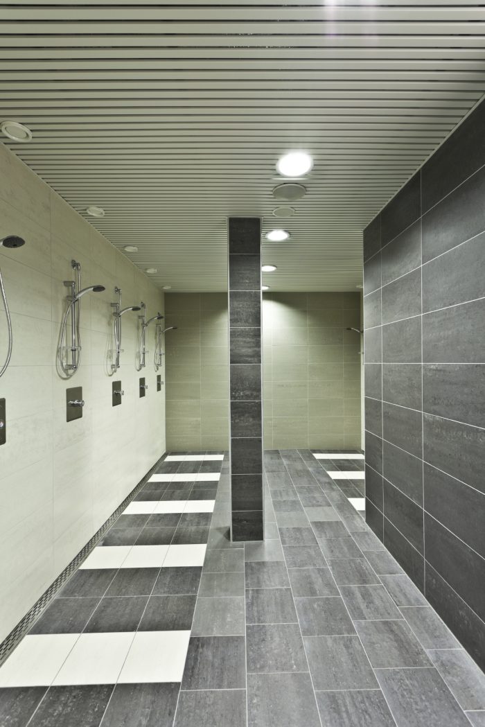 new puplic bathroom with many showers